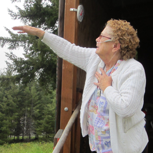 Cedar Valley resident points to the path of the helicopter that sprayed her home.