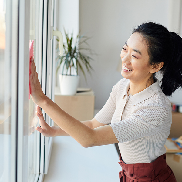 Young Asian Woman Cleaning Windows