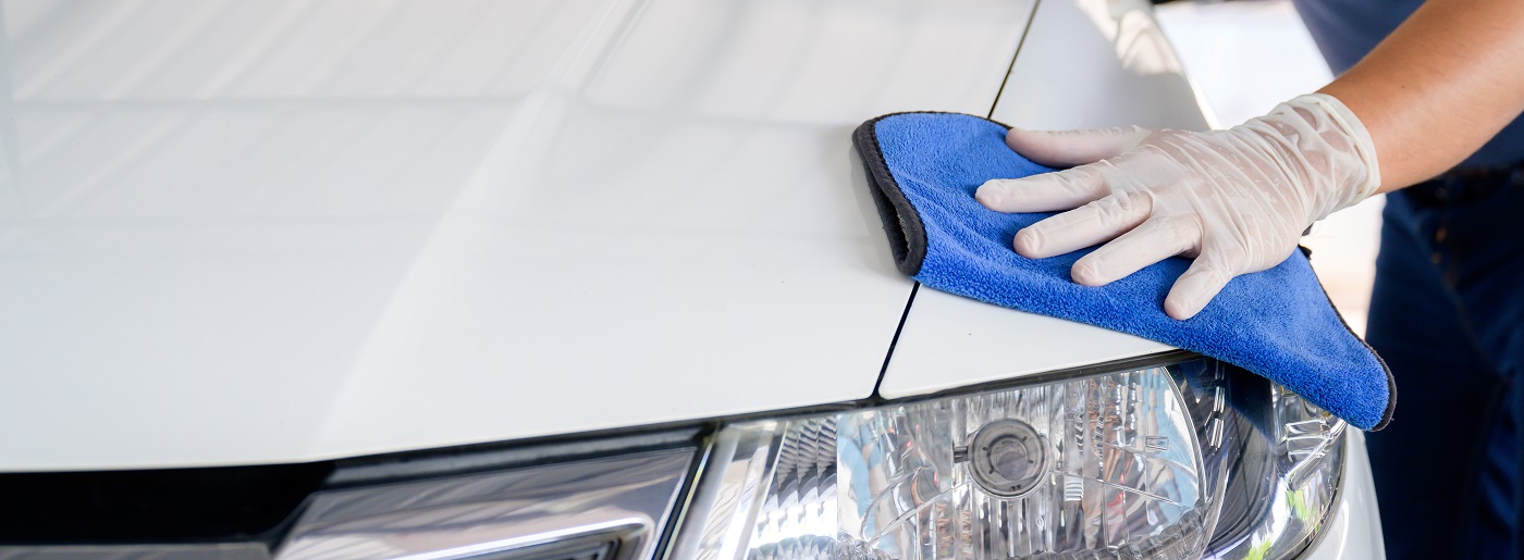 Car wash service personnel clean their cars with microfiber cloths. Details and valet concept Selective focus Close-up view