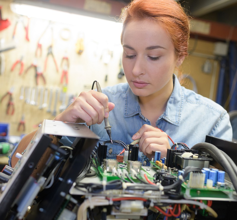 young woman technician repair electronics device toned image